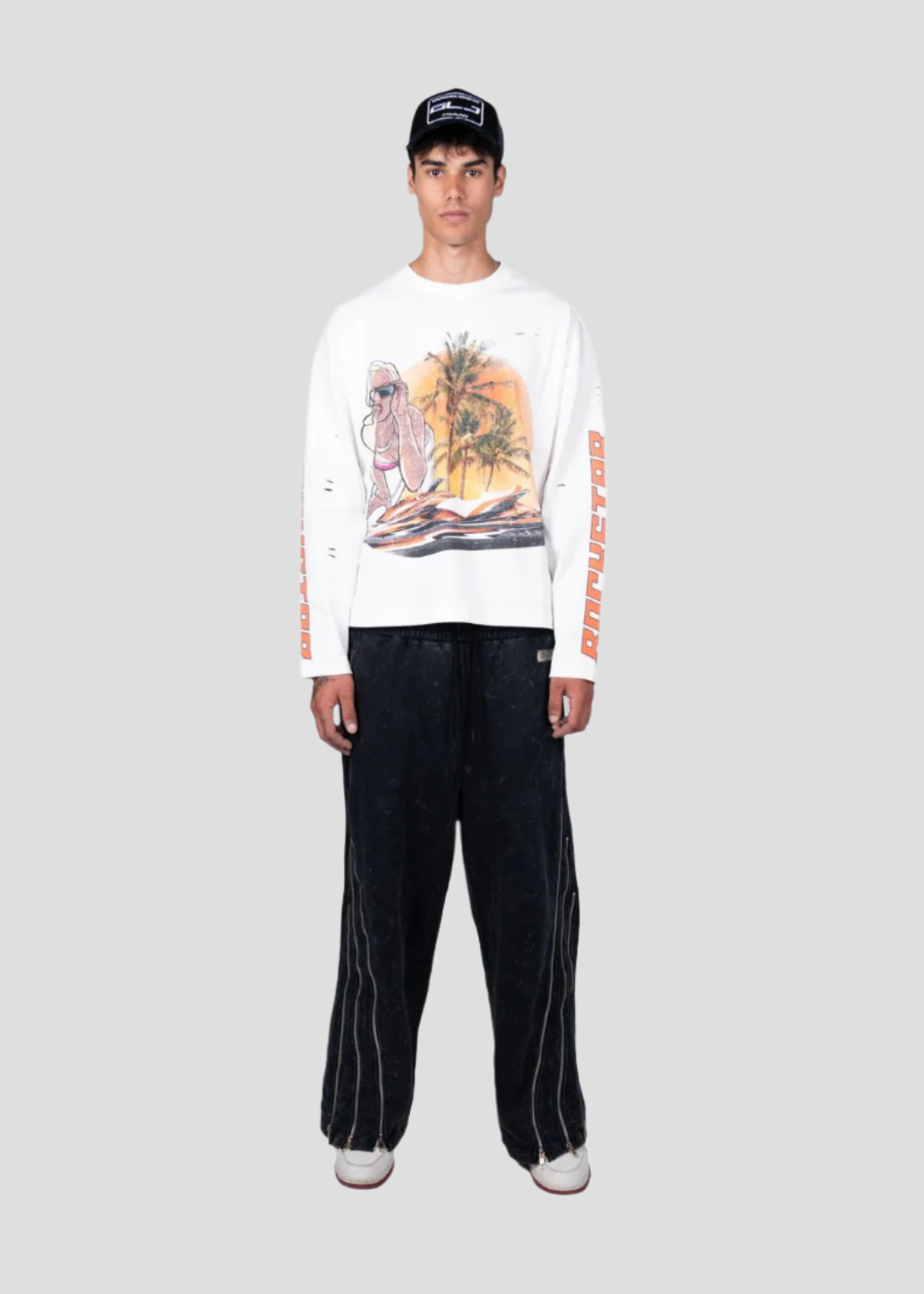 Person wearing a white graphic sweatshirt and black pants on a white background